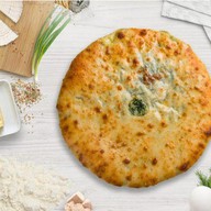 Осетинский пирог с сыром и зеленью Фото